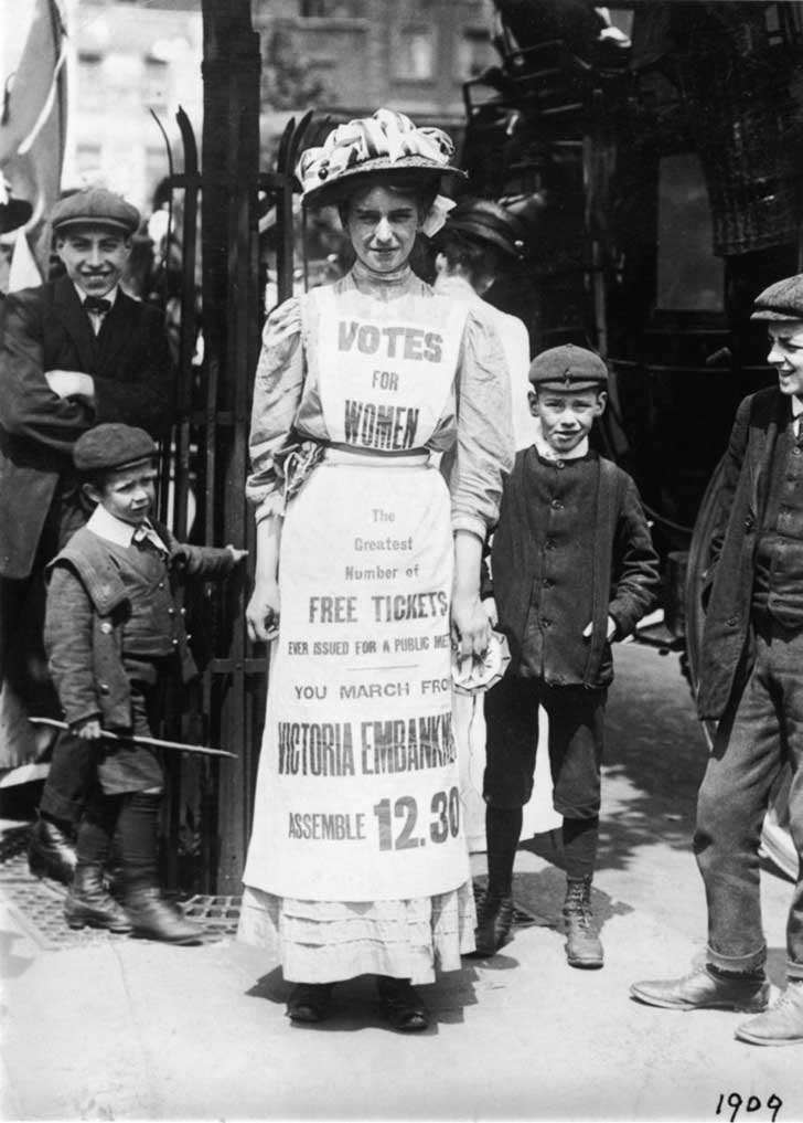 A young suffragette advertises a London march and rally, c.1909
