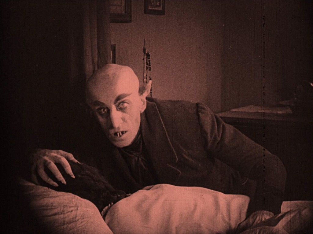 Nosferatu (1922) Max Schreck as Count Orlok feasting on his victim